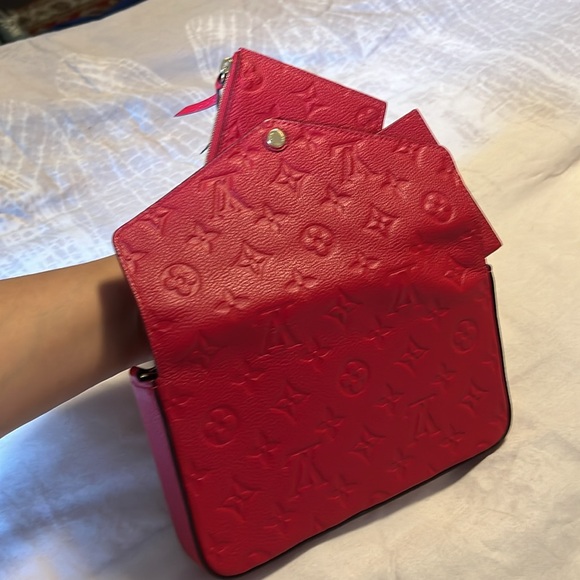 The Félicie Pochette RED is crafted from Monogram Empreinte leather. - Picture 2 of 4